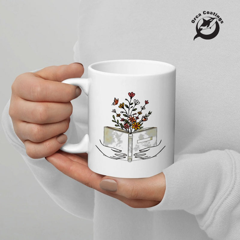 Tailorly White Ceramic 11 oz Mug - Wildflowers Growing From An Open Book Held By Minimalist Hands Book