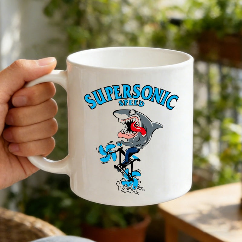 Tailorly White Ceramic 11 oz Mug - Supersonic Speed Fierce Animated Character Pedaling A Small Bicycle With Blue Swirling Speed Effects Shark