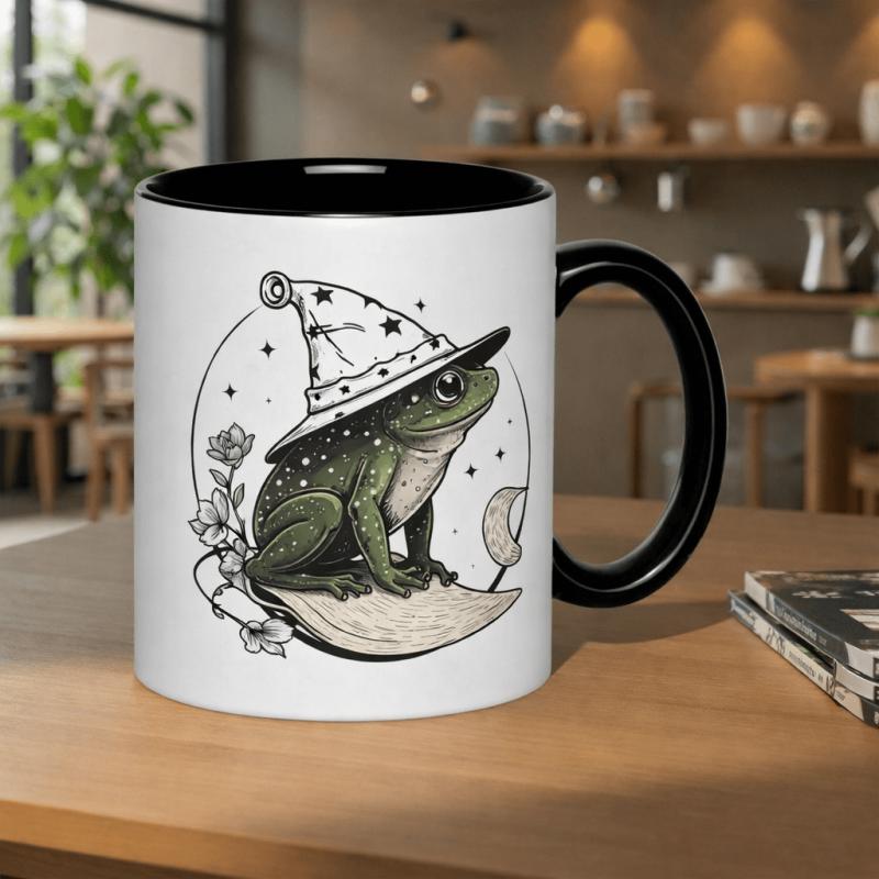Tailorly Black Accent 11 oz Mug - whimsical frog wizard wearing a starry hat and surrounded by flowers