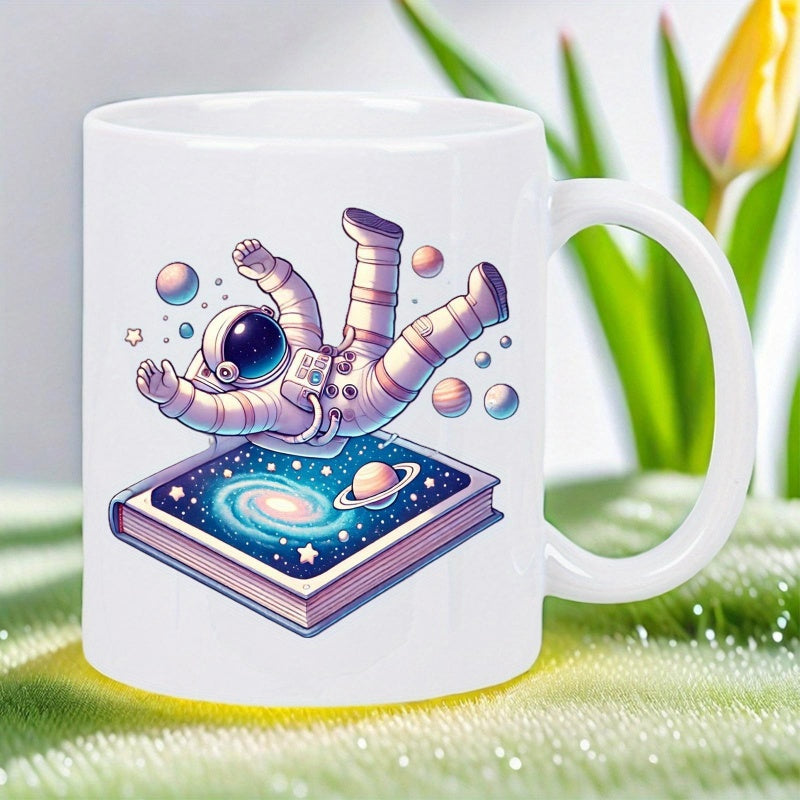 Tailorly White Ceramic 11 oz Mug - Floating Illustrative Space Traveler Above Book Displaying Cosmic Galaxy Scene And Planets Astronaut