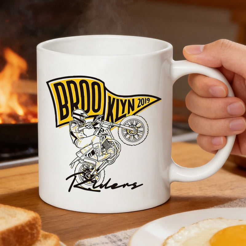 Tailorly White Ceramic 11 oz Mug - Brooklyn 2019 Riders Dynamic Stunt Person Performing High Wheelie Under Yellow Pennant Flag Rider