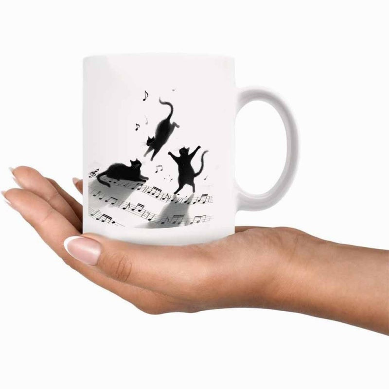 Tailorly White Ceramic 11 oz Mug - Playful Silhouetted Black Cats Dancing Upon Musical Staff Lines Cat