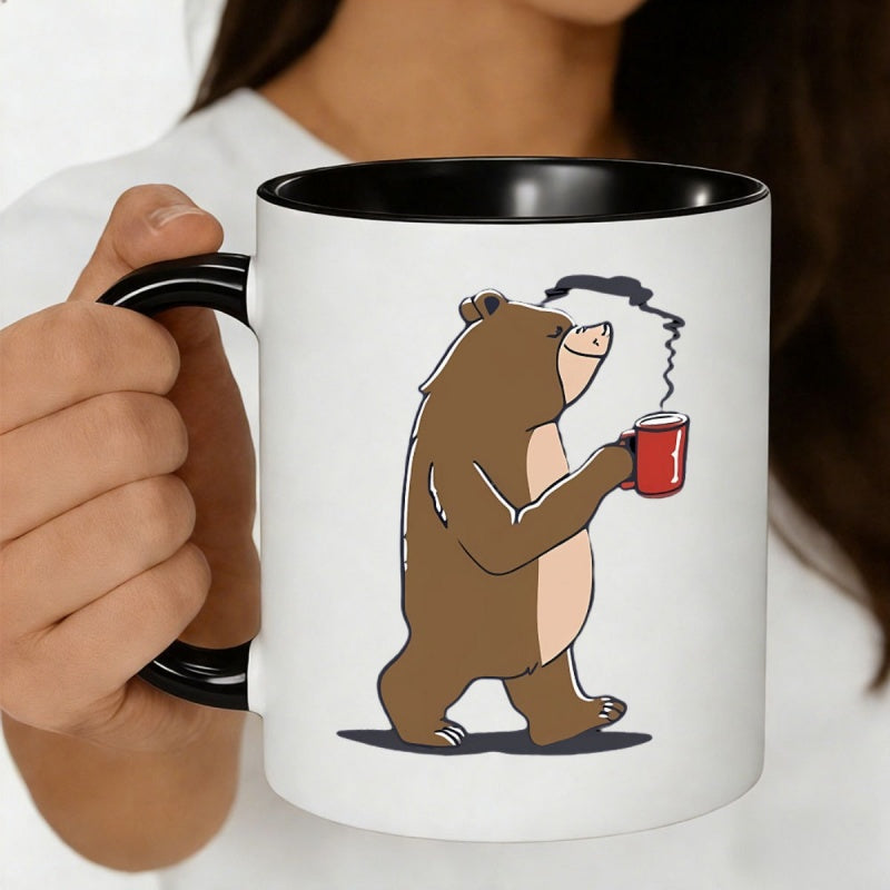 Tailorly Black Accent 11 oz Mug - an 11oz ceramic coffee cup featuring an adorable brown bear clutching a steaming a funny cartoon bear coffee mug