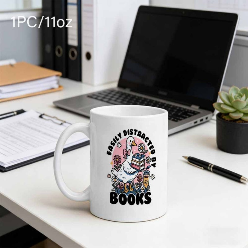 Tailorly White Ceramic 11 oz Mug - Easily Distracted By Books Charming White Goose Wearing Pink Bow Holding Stacked Books Surrounded By Floral Goose