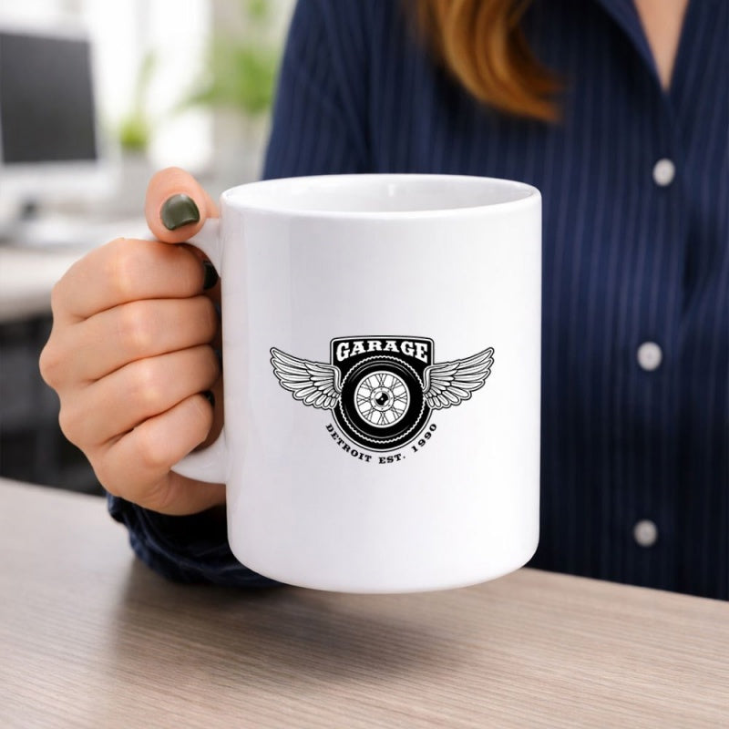 Tailorly White Ceramic 11 oz Mug - Garage Detroit Est 1988 Vintage Automotive Design With Extended Wings Flanking A Classic Circular Tire Wheel