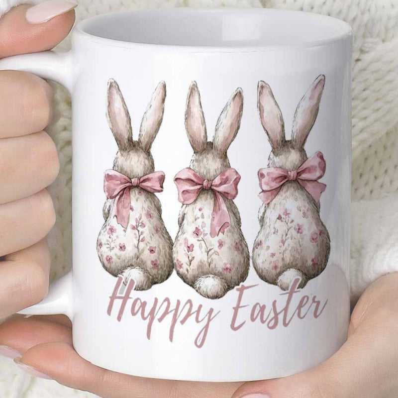 Tailorly White Ceramic 11 oz Mug - Happy Easter Three Floral Patterned Bunnies With Pink Bows Facing Away Rabbit