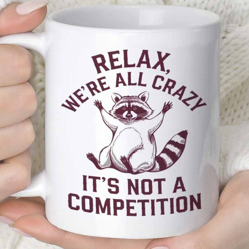 Tailorly White Ceramic 11 oz Mug - Relax We're All Crazy It's Not A Competition Cartoon Striped Tail Animal Sitting Calmly With Arms Outstretched Raccoon