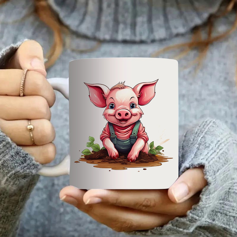 Tailorly White Ceramic 11 oz Mug - cartoon of a character in overalls sitting on mud with green leaves
