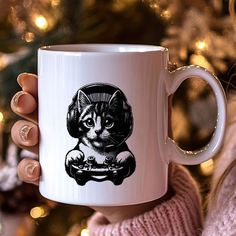 Tailorly White Ceramic 11 oz Mug - black and white cat gaming design with a tabby patterned cat wearing headphones and a game controller